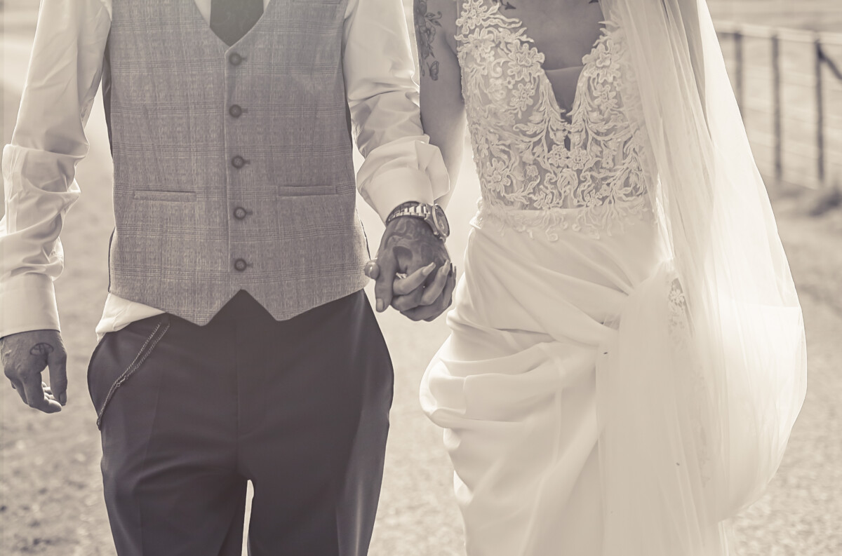Bride and groom holding hands – intimate wedding detail captured in Ireland